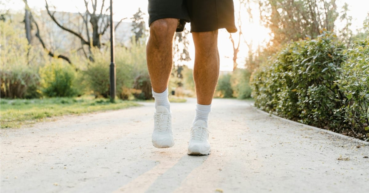 Man over 40 walking outdoors as part of a daily walking routine