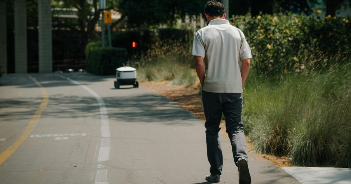 Man walking alone on a city path during the day