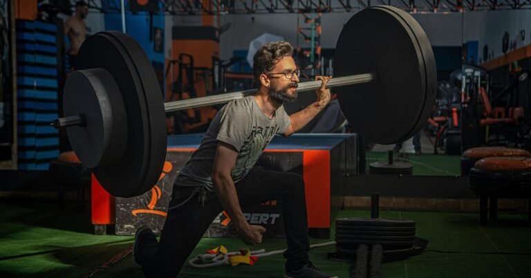 Man over 40 performing a controlled goblet squat with a barbell focusing on proper form