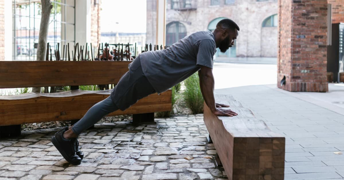 Man doing bodyweight squat exercise at home after 40
