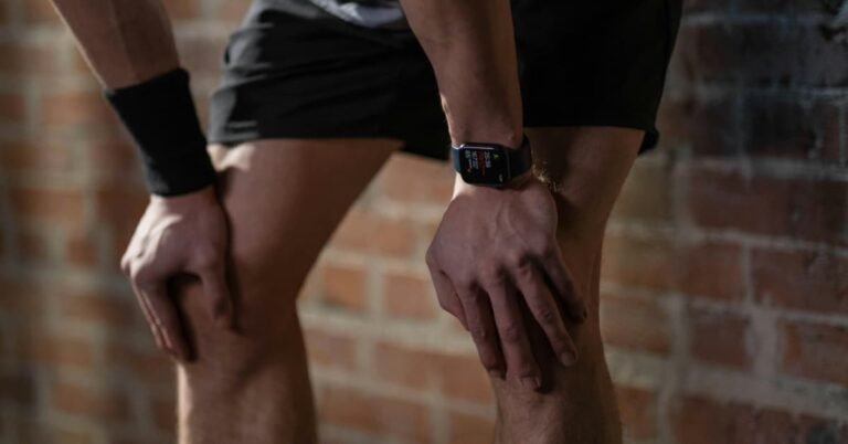 Man checking fitness tracker to monitor health and metabolism after 40