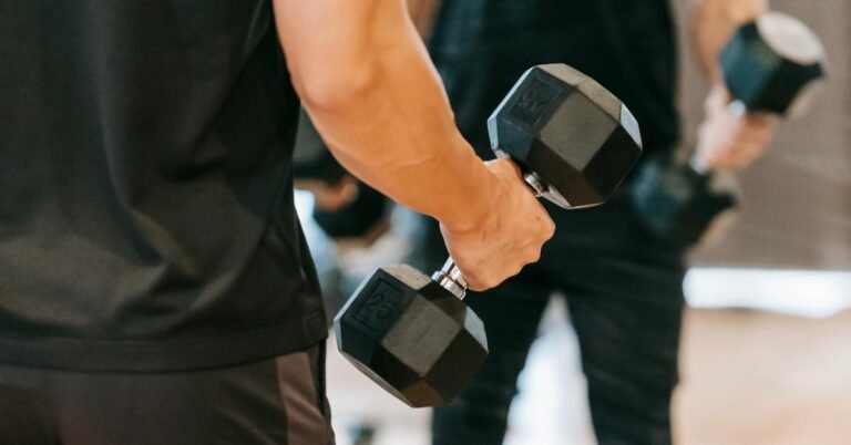 Man over 40 doing a dumbbell shoulder press at home after building his fitness base with daily walking