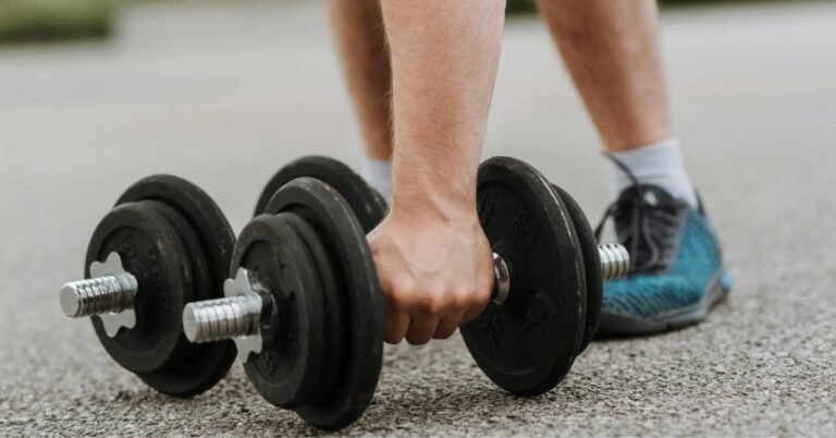 Man doing dumbbell rows at home after 40