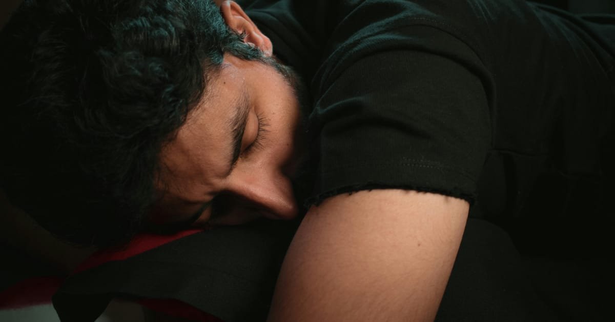 Man over 40 taking a short afternoon nap on a couch at home for better energy and focus