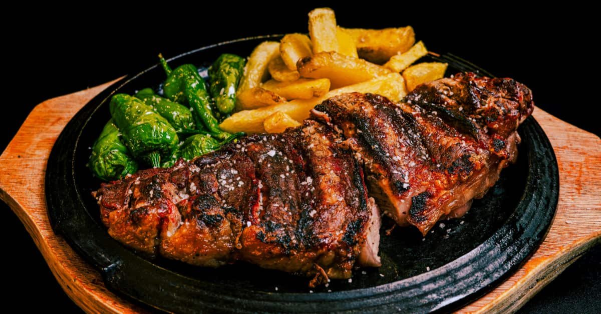 Man over 40 choosing a grilled protein dish at a restaurant while eating out mindfully