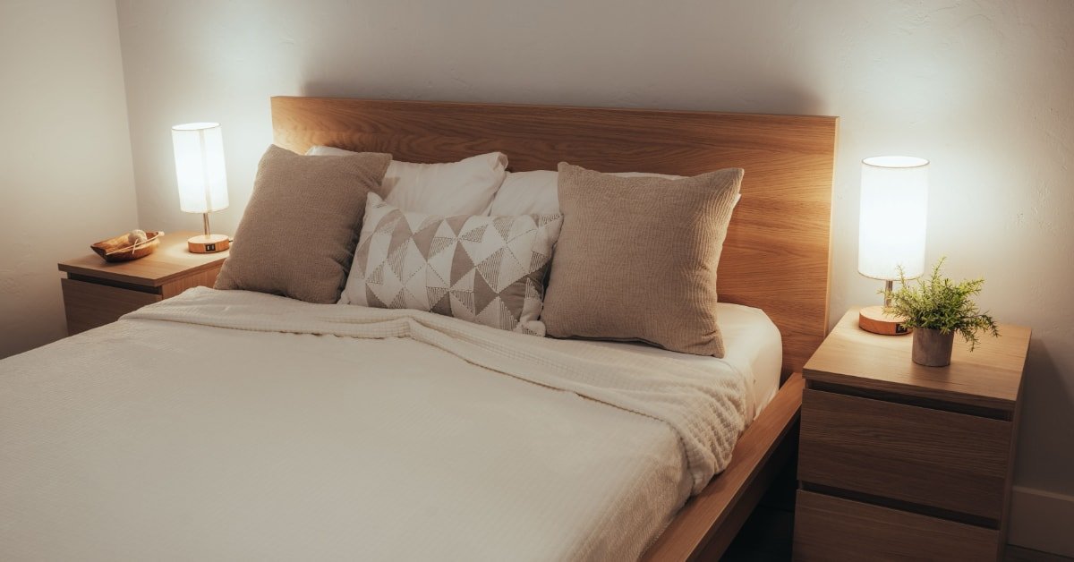Bedroom with blackout curtains, tidy setup and dim lighting, designed for better sleep after 40