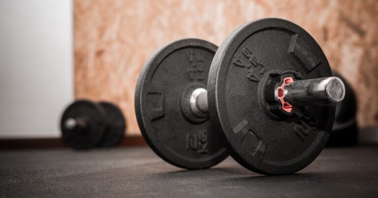 Man in his 40s doing dumbbell exercises at home, focused and controlled form